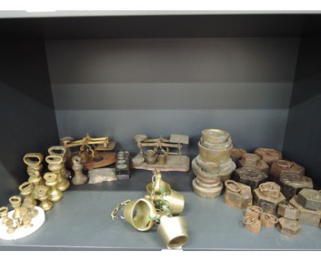 A quantity of weights including brass, postal scales, cow bells etc