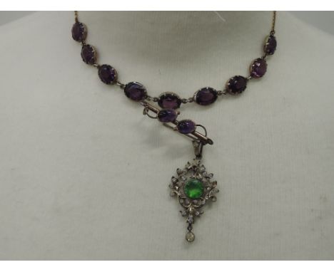 A diamante pendant with green paste dropper in white metal setting stamped 800, a necklace having 9 amethyst style stones in 