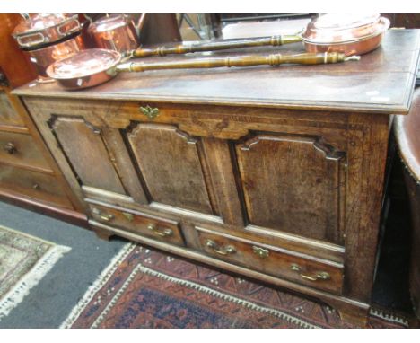 An 18th century oak mule chest having panel lift top and drawers under on bracket feet