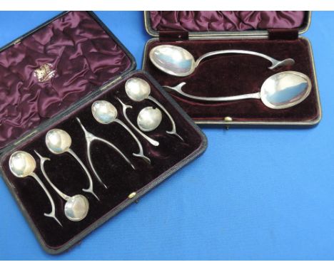 A cased set of six desert spoons in a stylised wishbone form and a matching cased pair of serving spoons, Birmingham 1905, Wi