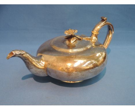 A Georgian silver teapot of plain squash form having ivory handle spacers and moulded floral knop and leaf to spout,  London 