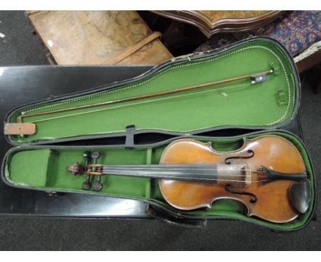 A late 19th/early 20th century violin bearing label Stradivarius, having 2 piece back with applique portrait cartouch for H J