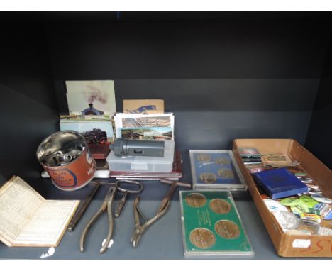 A selection of railwayana and related ephemera including ticket punches, door keys, whistles, postcards, badges etc