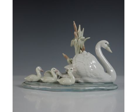 A graceful Lladro porcelain figurine titled Follow Me (01005722), depicting a mother swan leading her adorable cygnets across
