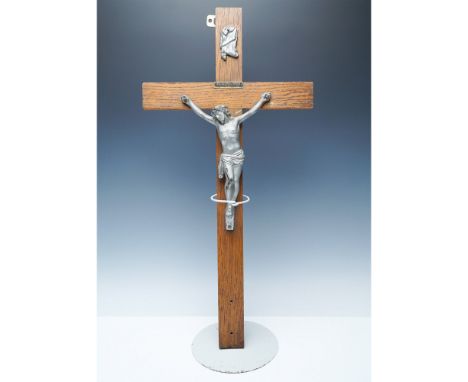 A striking large crucifix featuring a wooden cross with a cast metal figure of Christ. The metal elements have a vintage pati