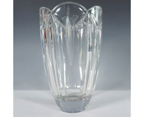 A striking cut crystal vase featuring an elongated fluted design with vertical cuts that create a prismatic effect. The scall