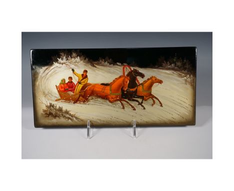 A painted Russian lacquer plaque in the Fedoskino style, depicting a traditional winter troika scene. The artwork features a 