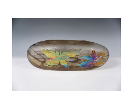This art glass piece features an iridescent floral motif set against a matte brown swirl background. The floral polished surf