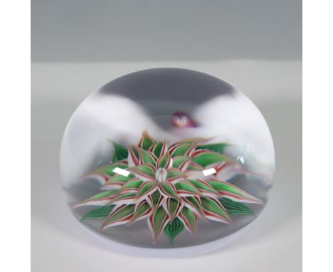 A Baccarat art glass paperweight featuring a delicately crafted lampwork flower with layered petals in shades of white, red, 