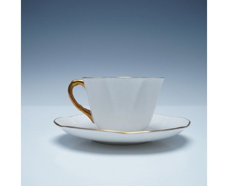 A timeless Shelley fine bone china tea cup and saucer set, featuring a refined fluted and scalloped design. The cup is adorne