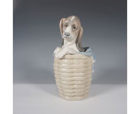 Charming Lladro porcelain figurine titled "Dog in Basket," model number 1128. Expertly crafted in Spain, this delightful figu