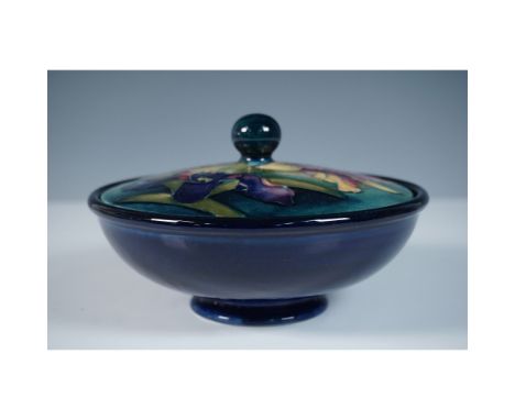 A Moorcroft pottery powder bowl featuring the iconic Iris pattern. The hand-painted design showcases richly hued iris flowers