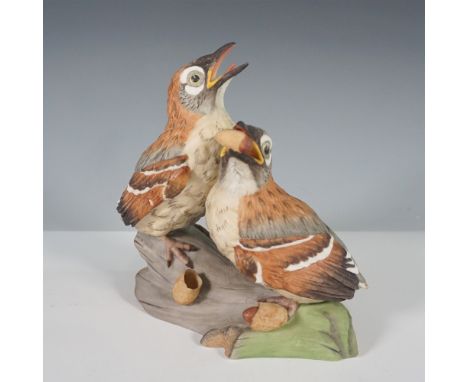 A beautifully detailed Boehm porcelain figurine featuring a pair of hedgling brown thrashers in a lifelike woodland scene. On