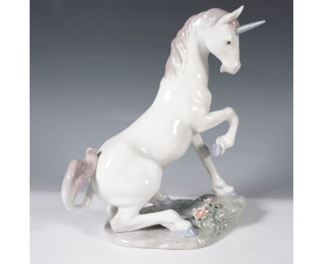 This figure depicts a rearing unicorn with a flowing mane and tail in soft pastel hues, featuring delicate floral embellishme