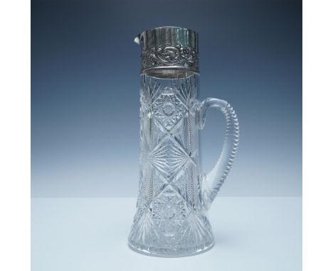 This elegant crystal pitcher features a striking American Brilliant Cut (ABC) design, characterized by intricate geometric pa