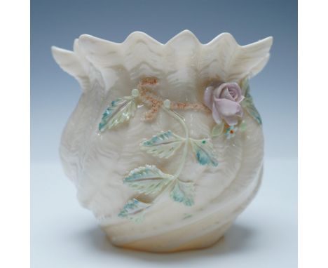 A delicate Belleek porcelain shell-shaped vase featuring hand-applied floral and vine decorations. This beautifully crafted p