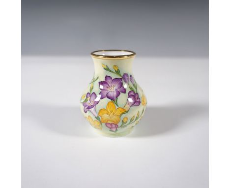 This Moorcroft enamel vase by Amanda Rose features a vibrant hand-painted floral motif with yellow and purple flowers, beauti