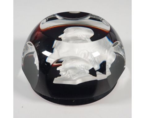 A Baccarat sulphide paperweight featuring a finely detailed cameo of Napoleon Bonaparte, set against a rich amber-hued ground