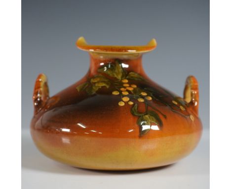 A beautifully crafted Rookwood Pottery handled vase, showcasing a rich burnt-orange and brown glaze with an embossed floral m