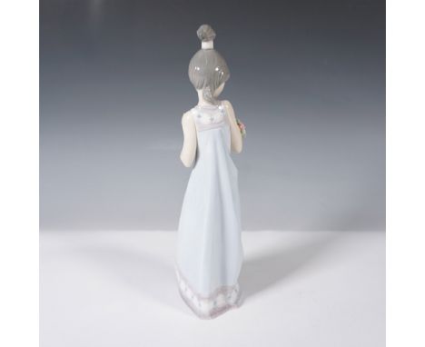 This piece captures a young woman in a flowing gown holding a bouquet of delicate flowers. The figure showcases Lladro's sign