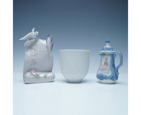 A lovely trio of Lladro porcelain pieces, including a scroll-form plaque with a dove (6.5"H) and quill, an embossed white cup