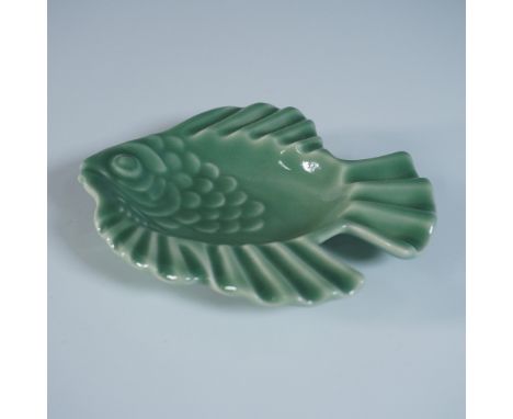 A charming Rookwood Pottery ceramic dish in the shape of a fish, featuring a rich green glaze that highlights the sculpted de