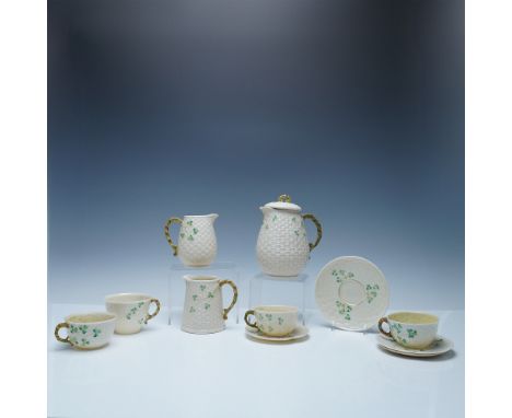A charming Belleek Parian porcelain tea set in the Shamrock pattern, featuring a delicate basketweave design accented with ha