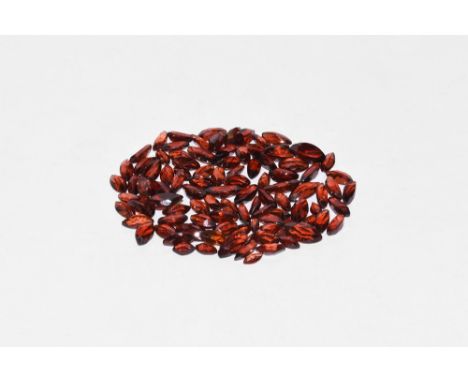 A group of one hundred marquise-cut garnets of a deep red-brown colour. 7.56 grams total, 4-8mm (1/4"). Extremely fine condit