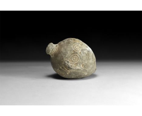 9th-11th century AD.A hollow ceramic vessel, ovoid in shape; the shoulder decorated with an impressed concentric ring designs