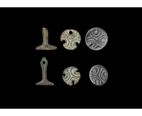 2nd century BC-1st century AD. A matched pair of bronze stamps, each a radiating tribract with round-section pierced shank.  