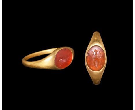 1st century BC-1st century AD.   A round-section hoop with flared shoulders, elliptical bezel with inset carnelian intaglio o