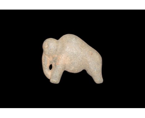 2nd millennium BC.A schist figure of a standing elephant, small head with curving trunk, small indents for eyes; arching back