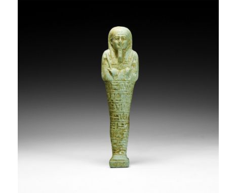 26th Dynasty, 664-525 BC. A large glazed composition shabti with mummiform body, wearing tripartite wig and false beard, arms