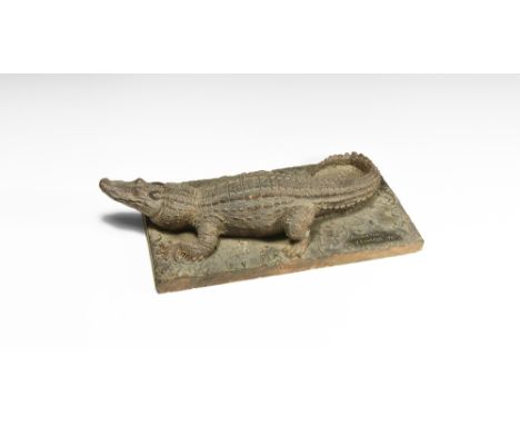 Dated 1930.   A master model in surface-treated plaster of an alligator on a textured rectangular base, with incised notation