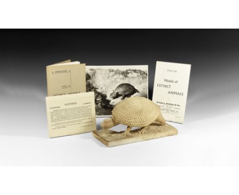 Circa 1930. A plaster model of a Glyptodon on a rectangular base, with recess to one long edge, two legs and both ears absent