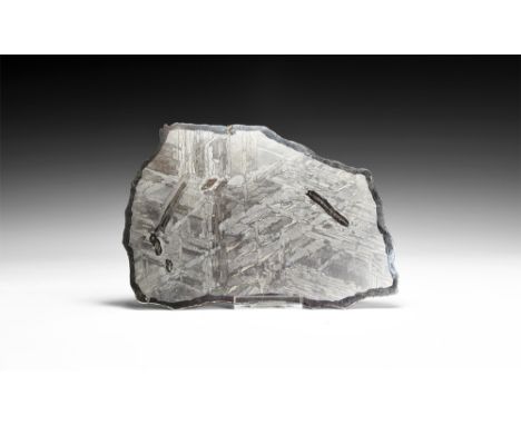 Discovered 1967.   A polished section slice of the meteorite, the cut surfaces showing the distinctive crystallisation and th