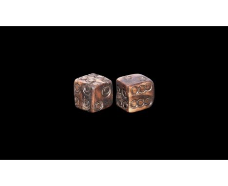 1st-3rd century AD.   A pair of miniature bone dice with annular spots, one arranged 1:2 3:4 5:6 and the other 1:6 2:5 3:4. C