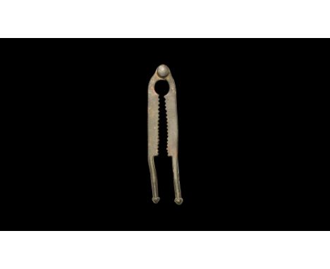 13th-14th century AD.An iron nutcracker with pivoting arms, circular slot and dentilled jaws, round-section arms each with ch