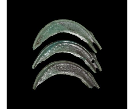 2nd millennium BC.   A group of three bronze sickle blades, each with reinforcing rib to the outer edge, attachment slot. 81 