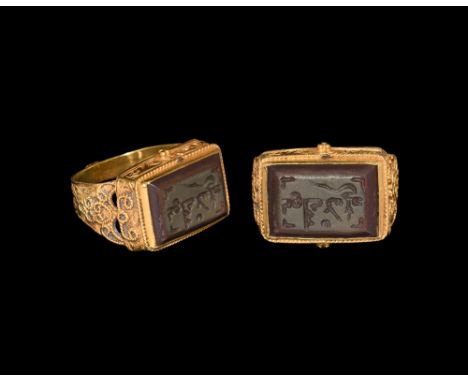 13th-15th century AD.   A jasper intaglio with calligraphic text and tendrils, set into a later flat-section gold hoop with s