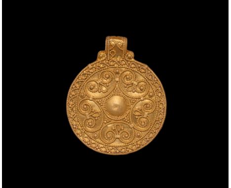 9th-11th century AD.   A gold discoid pendant with central motif of a five-pointed star formed around a large central raised 
