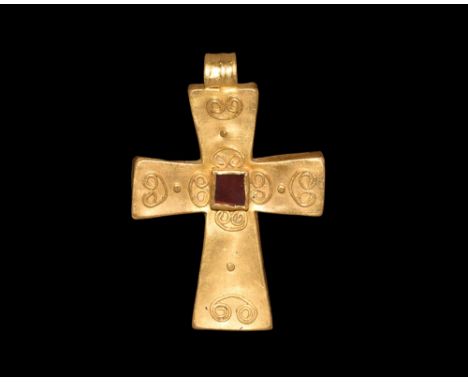 8th-9th century AD.   A hollow-formed gold foil cross pendant with expanding arms, ribbed suspension loop, applied filigree v