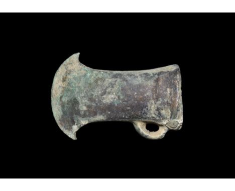 2nd millennium BC.A hollow-formed bronze socketted axehead with square-section mouth and shallow horizontal rib below, flared