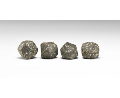 A group of four dodecahedral garnet crystals, probably almandine; in old white card tray. See Bonewitz, Dr. Ronald Louis, Roc