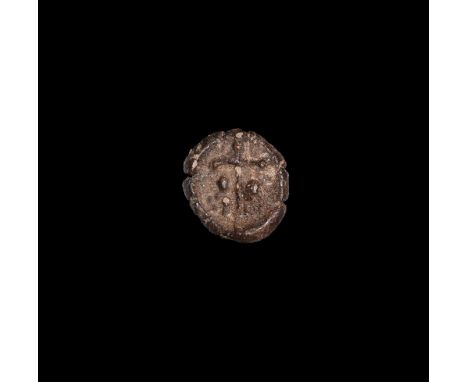 11th-15th century AD.A round ceramic pilgrim's token with a cross to the centre and two small figures to either side. 1.81 gr