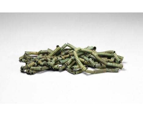8th-4th century BC.   A restrung necklace of bronze coiled strips forming tube-shaped beads of varying sizes. 429 grams, 378c