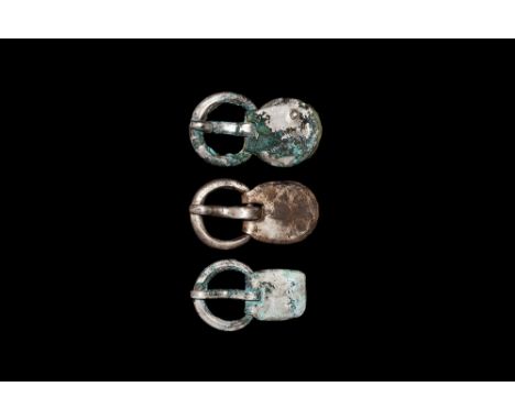 5th century AD.A mixed group of silver buckles comprising: a pair, each with substantial round-section loop, D-section tongue