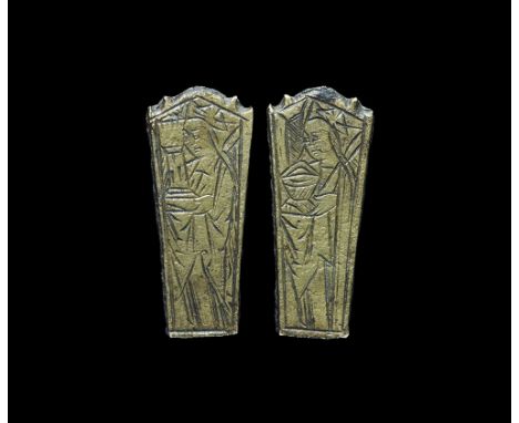 14th century AD.A bronze knife handle finial, tapering in profile with scrolled upper edge; to one face the incised design of