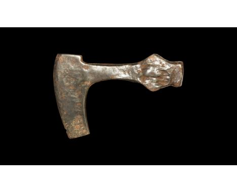 9th-11th century AD.An iron axehead with T-shaped blade, curved edge, lateral wings to the socket, hammer face to the rear. C