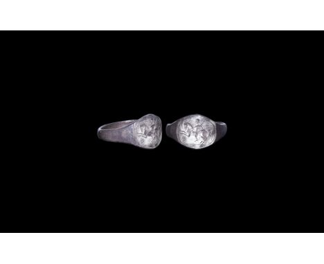 1st century BC.A flat-section silver hoop with flared shoulders, discoid bezel with intaglio image of a horseman advancing be